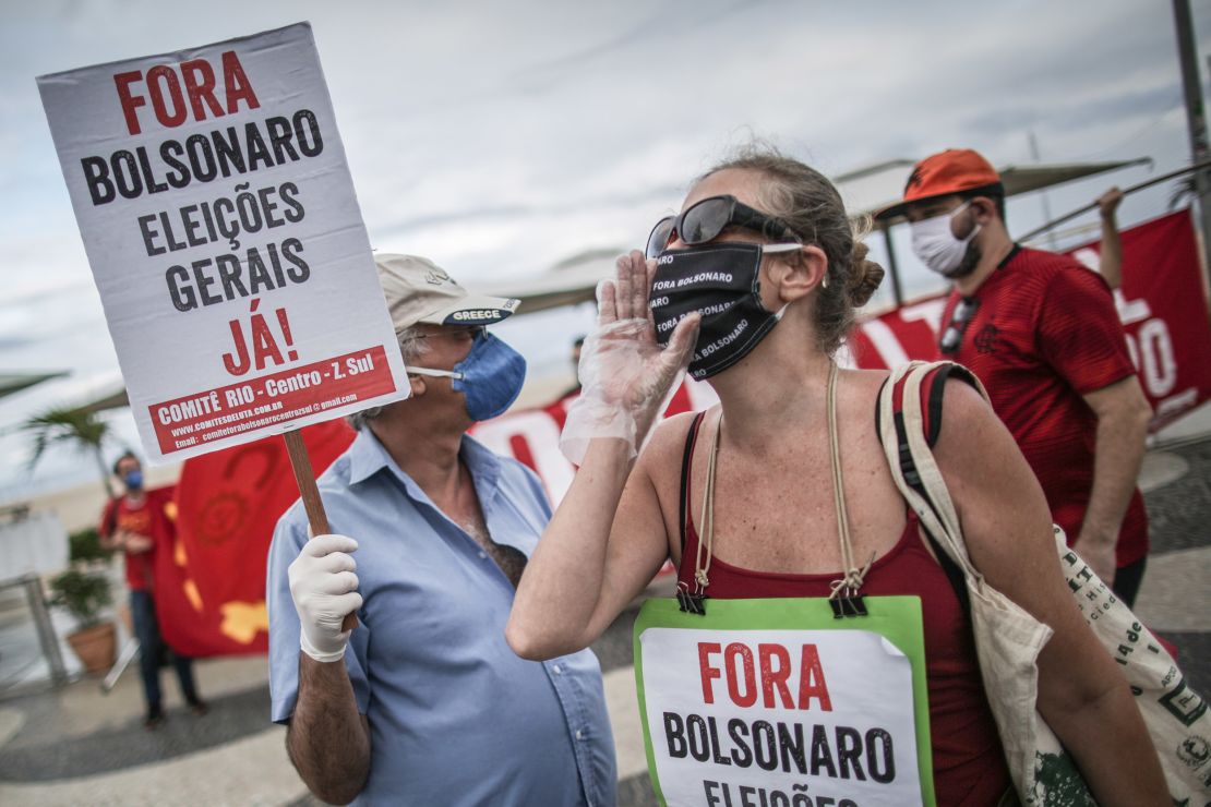 A demonstrator holds a sign that reads 