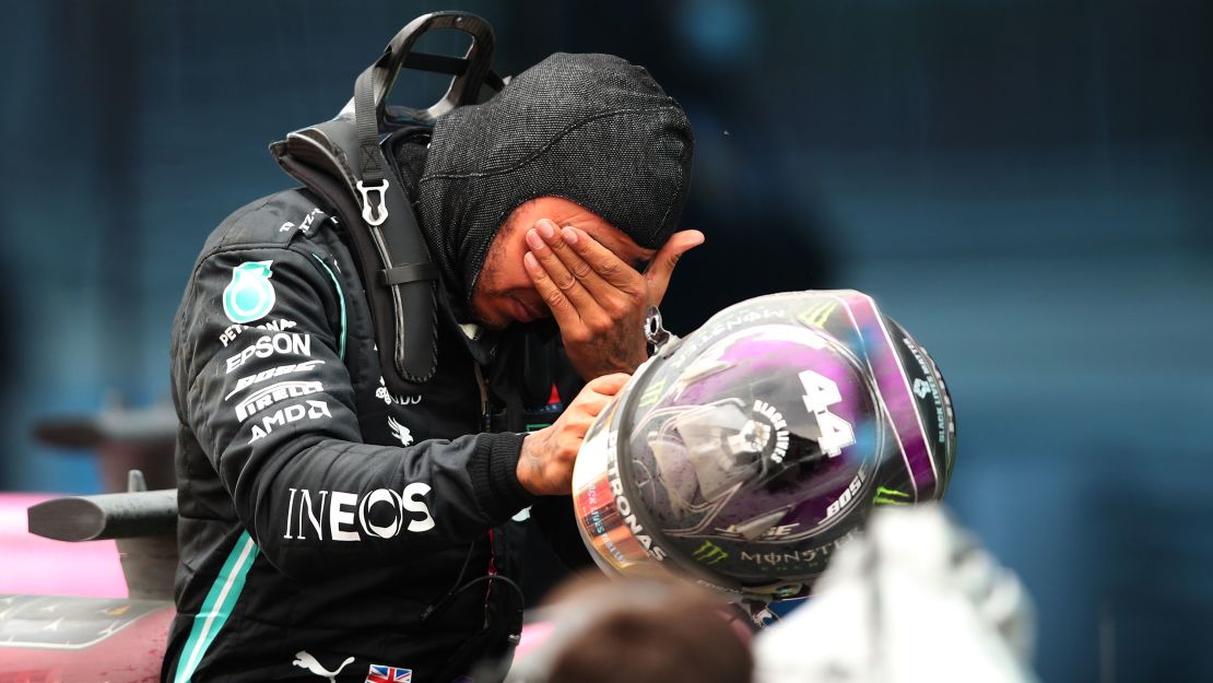 An emotional Hamilton celebrates with his Mercedes team after the race. 