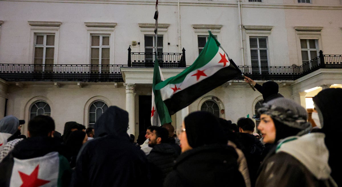 People wave Syrian opposition flags as they gather outside the Syrian embassy, after Syrian rebels announced that they have ousted Syrias Bashar al-Assad, in London, Britain December 8, 2024. — Reuters