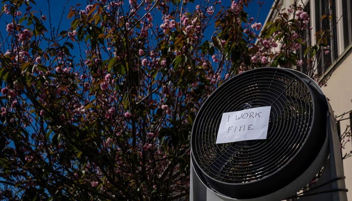 A fan sits at a street corner with a note that reads I work fine during a heat wave as temperatures climb over 80 Fahrenheit (26.7 degrees Celsius), in San Francisco, California, US, July 2, 2024. — Reuters