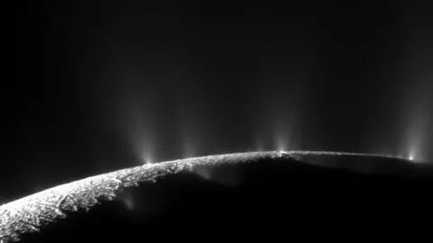 NASA Plumes of material coming from Enceladus, one of the moons of Saturn, indication a sub-surface ocean.