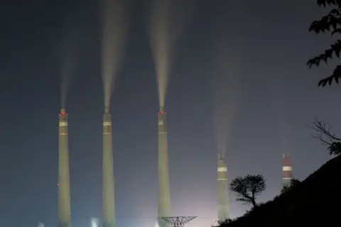 Getty Images View of Suralaya coal power plant while smoke and steam billows seen from Suralaya village in Banten province, Indonesia