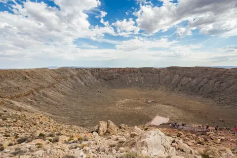 Getty Images A photograph of the Barringer Crater in Arizona, US was formed by a meteorite about 50m across that hit 50,000 years ago