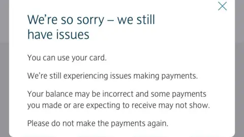 A white box with black text that says: "We're so sorry - we still have issues. You can use your card. We're still experiencing issues making payments. Your balance may be incorrect and some payments you made or are expecting to receive may not show. Please do not make the payments again."