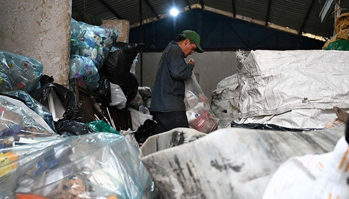 A recycler works at a recycling warehouse in Bogota on February 26, 2025. — AFP