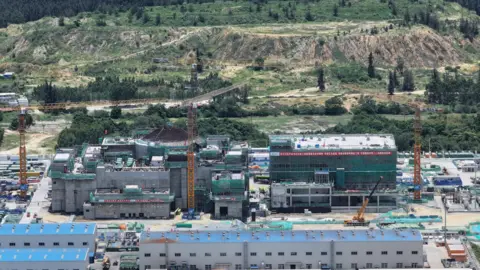 Getty Images An aerial view of an SMR in China - a collection of buildings on an industrial-looking site with hills and trees in the background 