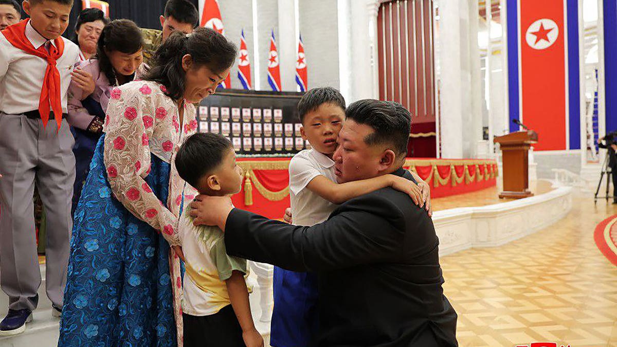 Kim hugs children of fallen soldiers