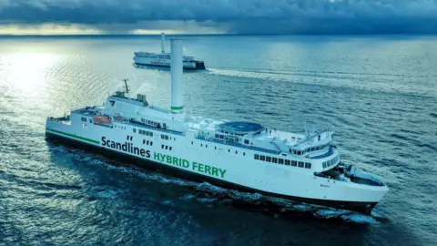 Norsepower Two large, white ferries are seen passing each other in open seas.  On the decks is a helideck and a single large rotating tower.