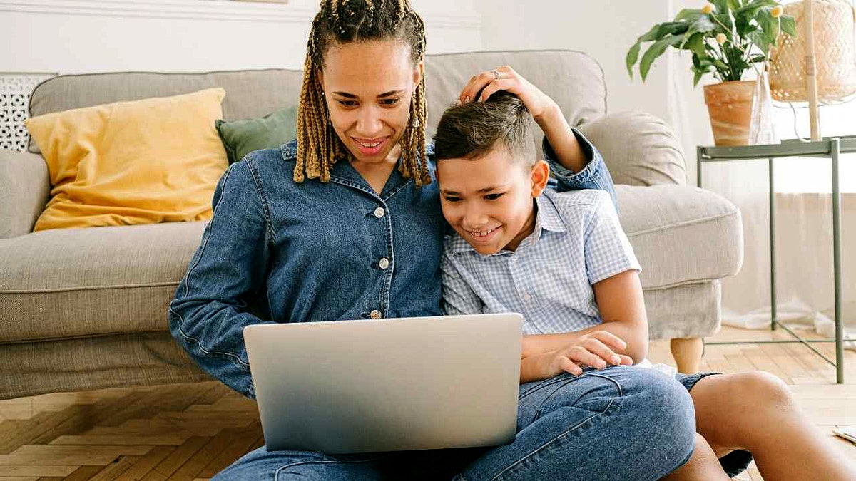 A mother surfs the web with her son.